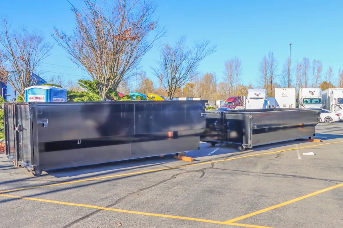 Professional dumpster rental service with roll-off container on residential driveway in Tallulah